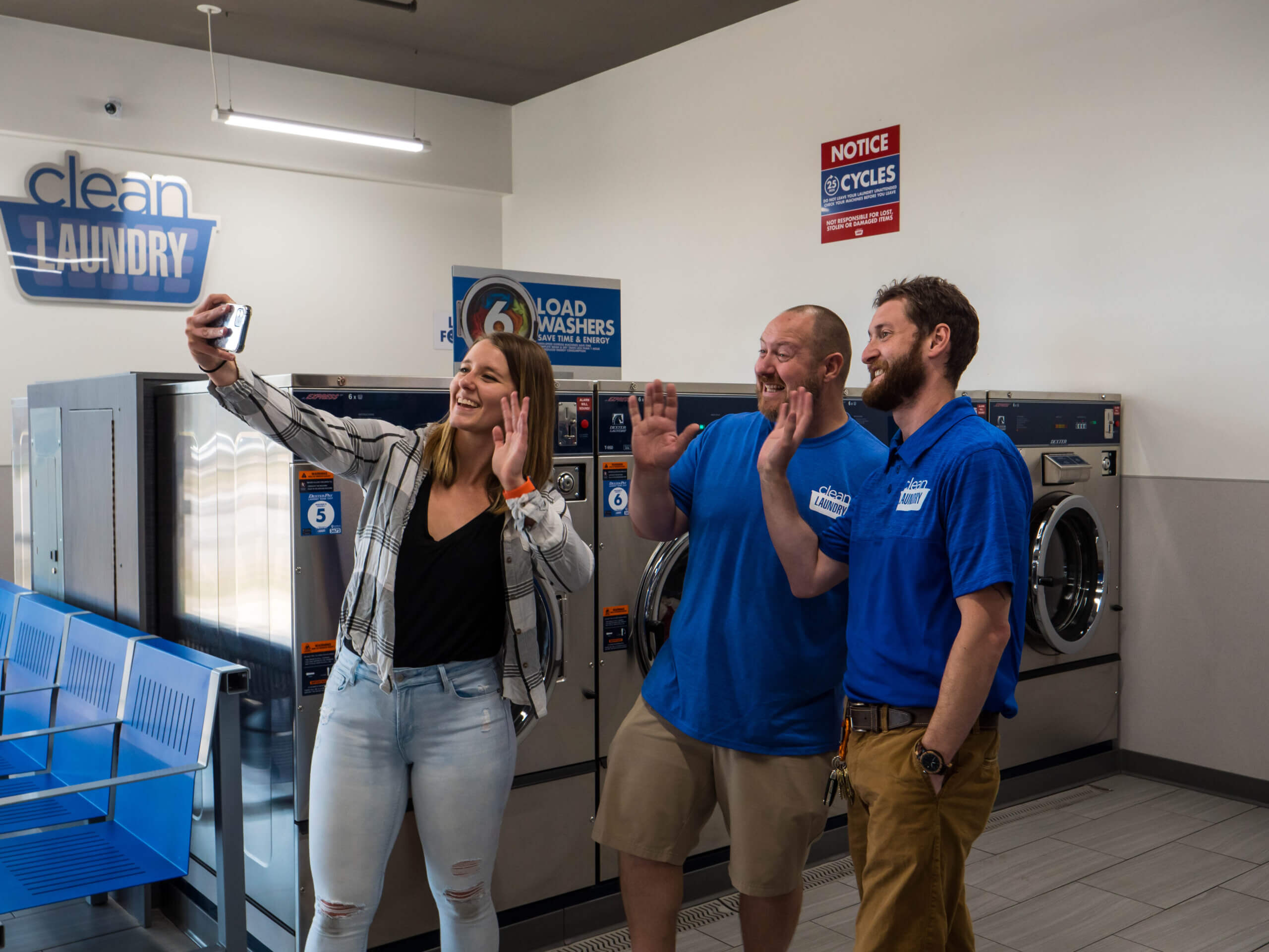 Customer takes selfie with Clean Laundry employees
